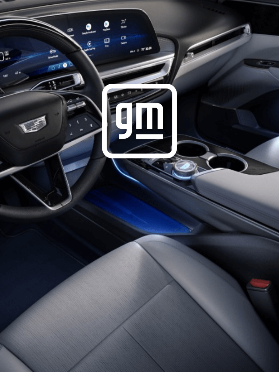 The interior of an automobile with the GM logo overlayed.